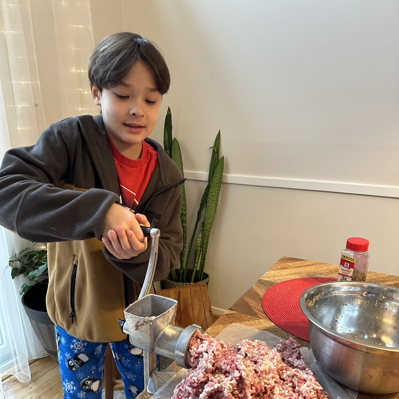 Teaching my mini-me how to make sausage on a vintage grinder from the USSR